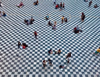 High angle view of people standing on tiled floor