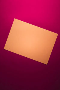 High angle view of paper against colored background