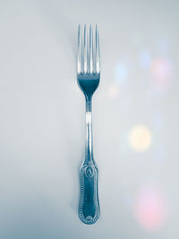 Close-up of electric lamp on table against white background