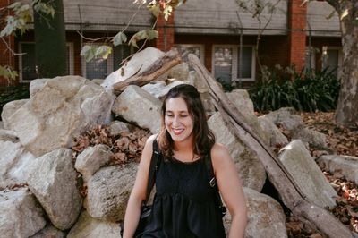 Portrait of smiling young woman standing outdoors