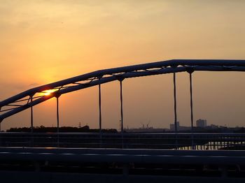 Silhouette bridge against sky during sunset