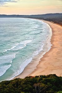 Scenic view of beach against sky during sunset