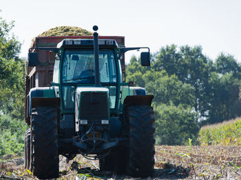 Tractor on field against sky