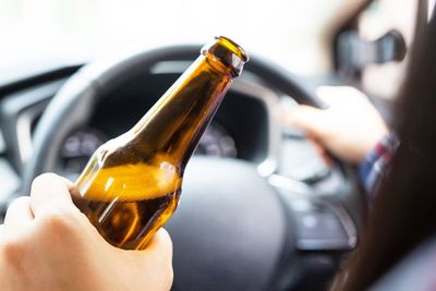 Close-up of hand holding beer glass