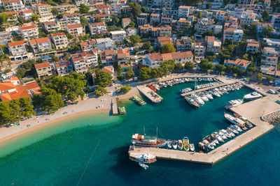 Aerial view of brela town below biokovo mountain, the adriatic sea, croatia