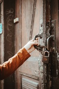 Close-up of hand by door