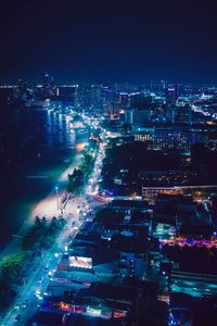 High angle view of illuminated buildings in city at night