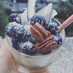 Close-up of hand holding ice cream in bowl