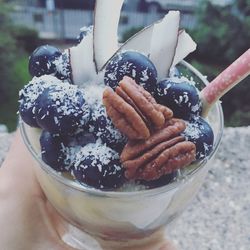 Close-up of hand holding ice cream in bowl