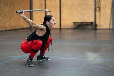 Full length of woman exercising in gym