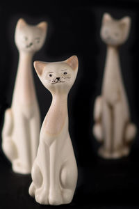 Close-up of figurine on table against black background