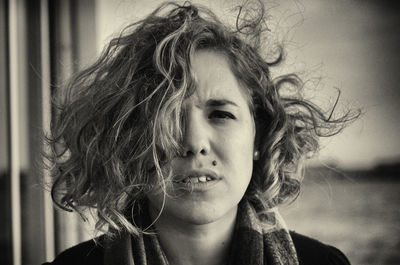 Close-up portrait of woman with tousled hair