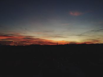 Silhouette of landscape against sky at sunset