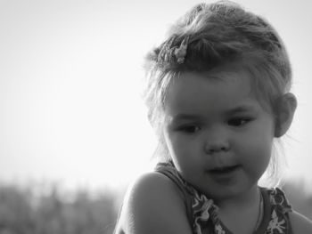 Close-up of cute girl looking away