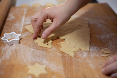 Midsection of person with cookies on table