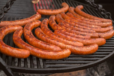 Sausages cooking in barbecue grill