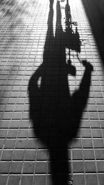 Shadow of man and woman standing on tiled floor