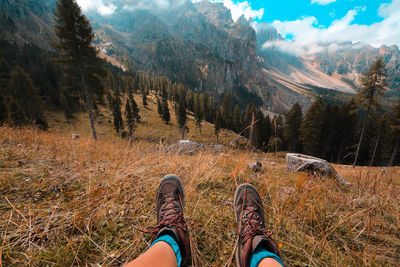 Low section of man standing on mountain