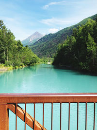 Scenic view of swimming pool by lake against sky