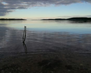 Scenic view of lake against sky at sunset