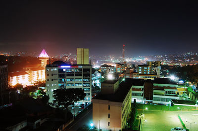 High angle view of illuminated buildings against sky at night