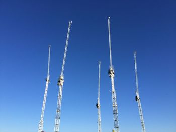 Low angle view of crane against clear sky