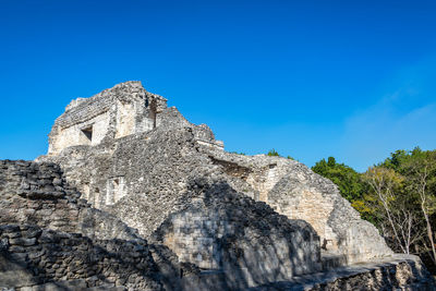 Low angle view of castle against clear blue sky