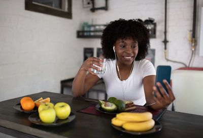 Ethnic woman talking with family online