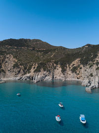 Scenic view of sea and bay against clear blue sky