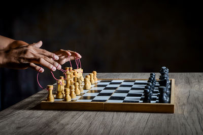 Low angle view of person playing on chess board