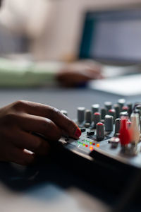 Cropped hand of woman holding buttons