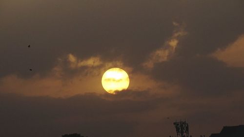 Low angle view of silhouette moon against sky during sunset