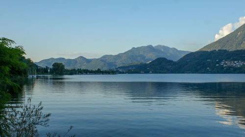 Scenic view of lake and mountains against sky