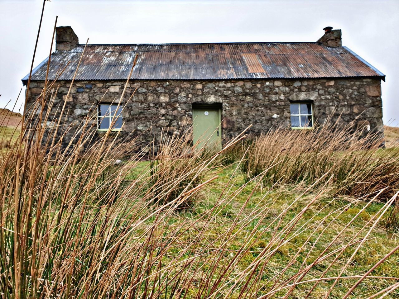 EXTERIOR OF OLD HOUSE ON FIELD