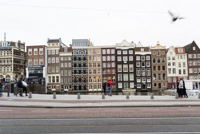 City street by buildings against sky