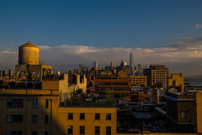 High angle view of buildings against cloudy sky