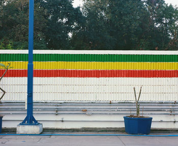 Close-up of railing against blue wall