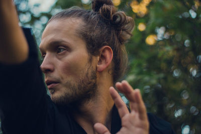 Close-up portrait of young man looking away