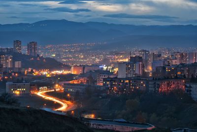 High angle view of illuminated buildings in city at dusk