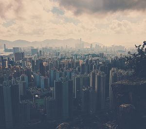 Cityscape against cloudy sky