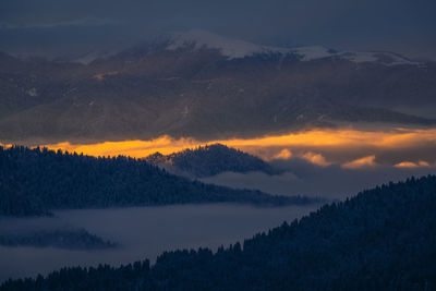 Scenic view of silhouette mountains against sky during sunset