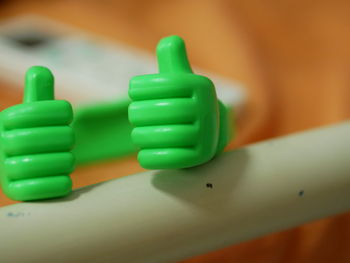 Close-up of thumbs up toy