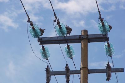 Low angle view of communications tower against sky