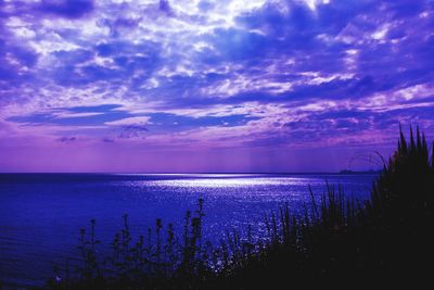 Scenic view of sea against cloudy sky