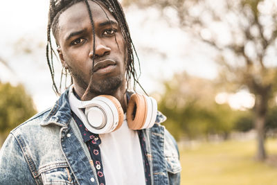 Portrait of young man looking away outdoors