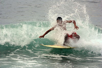 People surfing in sea