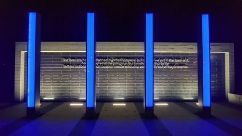 Illuminated lights on subway station platform at night