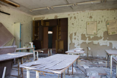 Empty chairs and tables in abandoned building