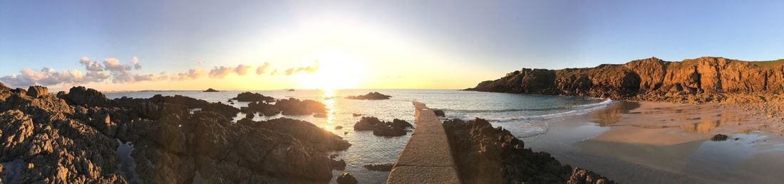 Panoramic view of rocks in sea against sky