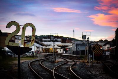 Railroad tracks against sky during sunset